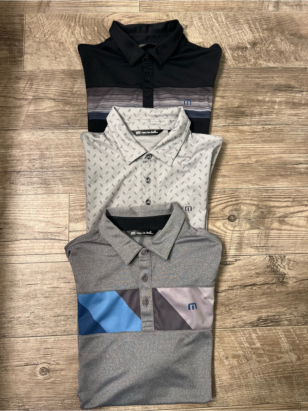 Travis Mathew Men’s Polo Trio in Black, Gray, and Light Gray with Blue Accents